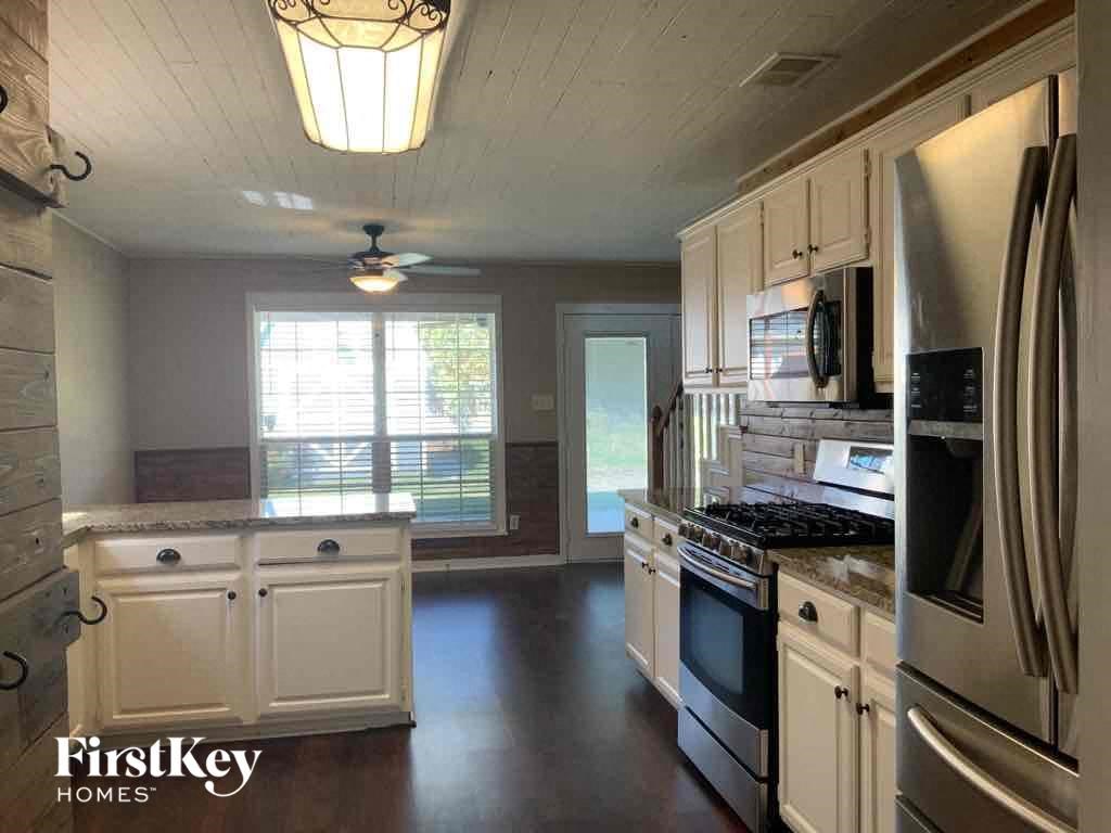 a kitchen with stainless steel appliances and white cabinets