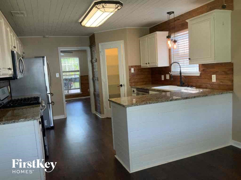 a kitchen with a counter top and a refrigerator