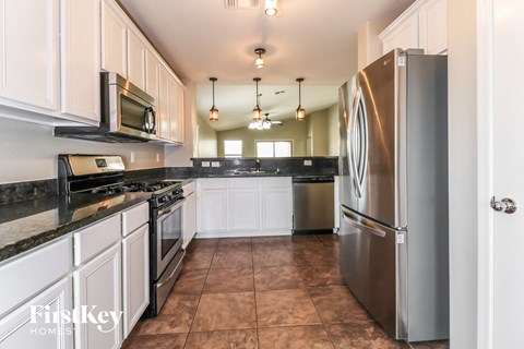 a kitchen with stainless steel appliances and white cabinets