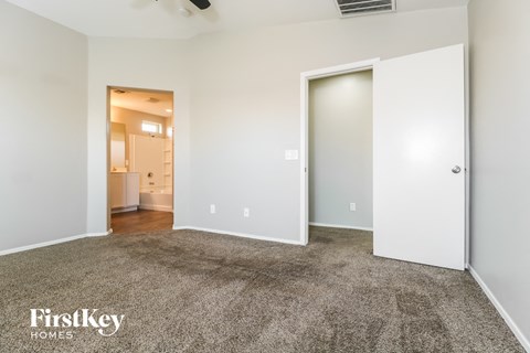 a living room with carpet and a door to a bathroom