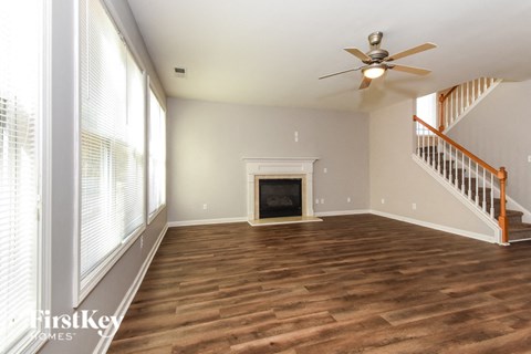 a living room with wood flooring and a fireplace