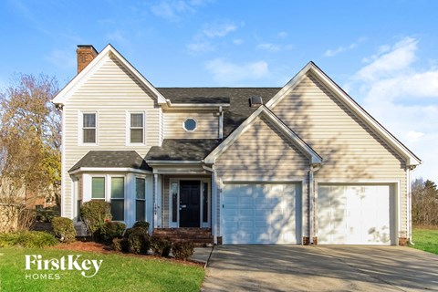 a home with a white garage door and a white house