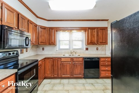 a kitchen with wooden cabinets and black appliances