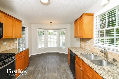 a kitchen with wooden cabinets and a sink and a window
