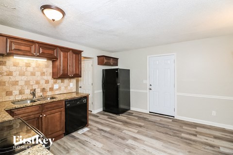 a kitchen with a refrigerator and a sink