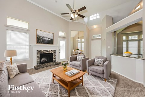 A living room with a fireplace and a painting on the wall.