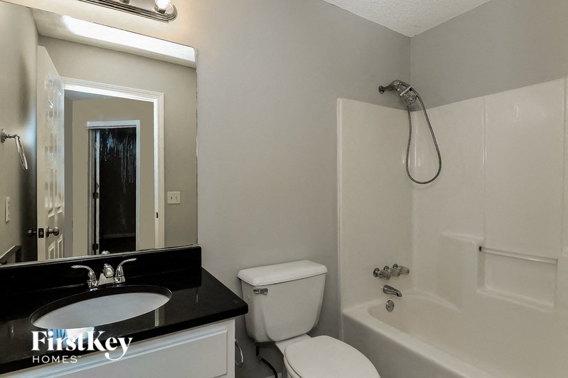 a bathroom with a sink toilet and a shower