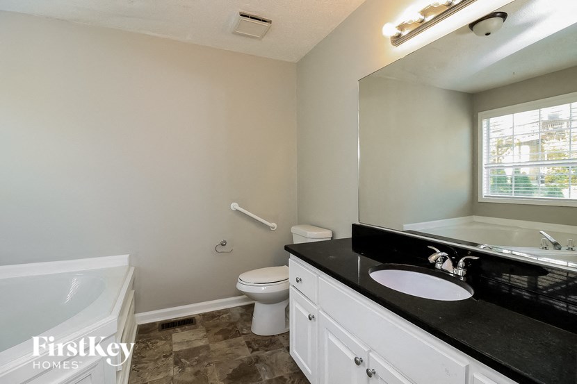 a bathroom with a sink toilet and a bath tub