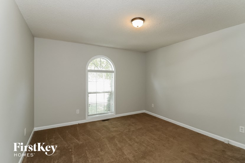 the living room of an empty house with a window