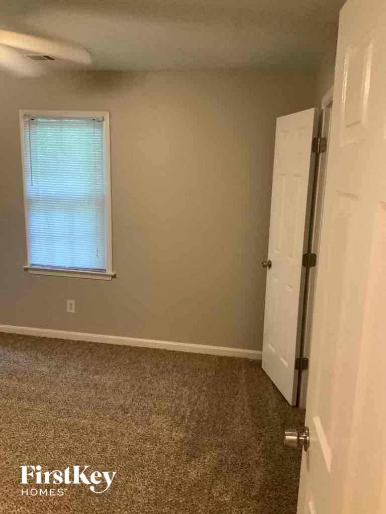 an empty room with a door and a window