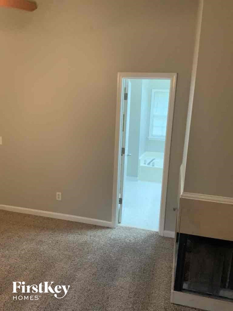 a room with a fireplace and a door to a bathroom