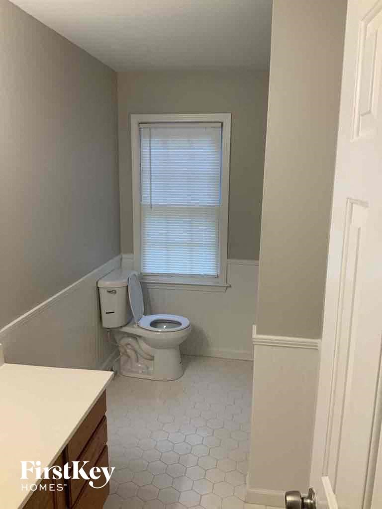 a small bathroom with a toilet and a window