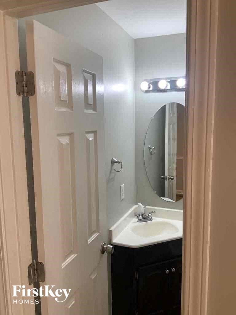 a small bathroom with a sink and a mirror
