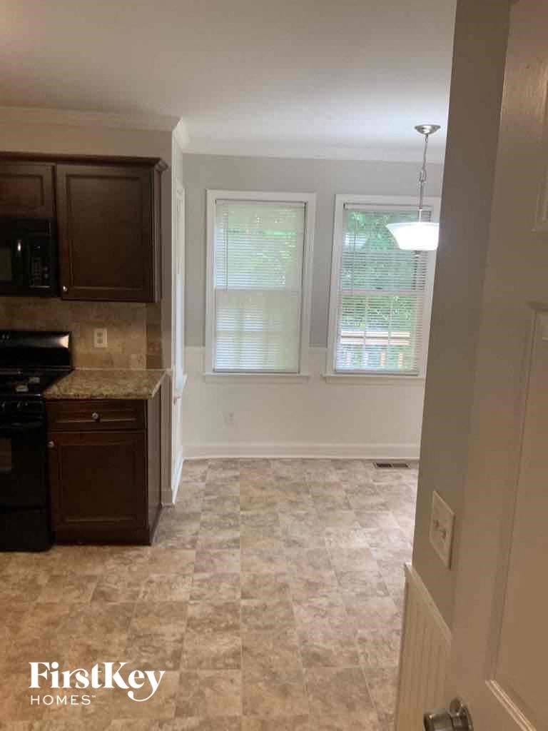 an empty kitchen with a sink and a window