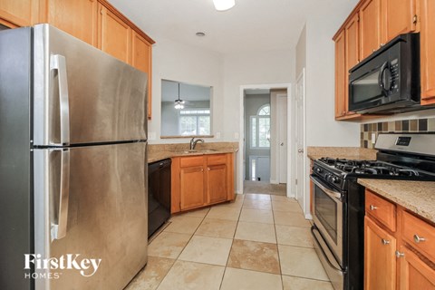 a kitchen with stainless steel appliances and wooden cabinets