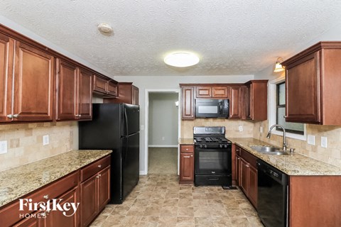 a kitchen with wood cabinets and black appliances