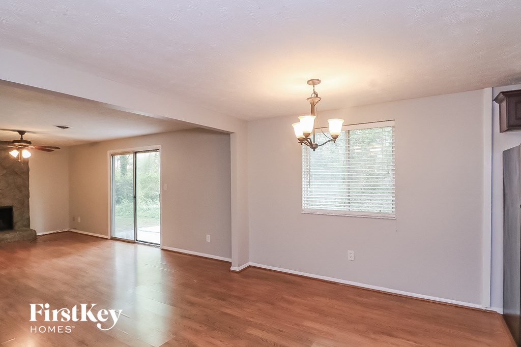 A spacious room with a fireplace and sliding glass doors.