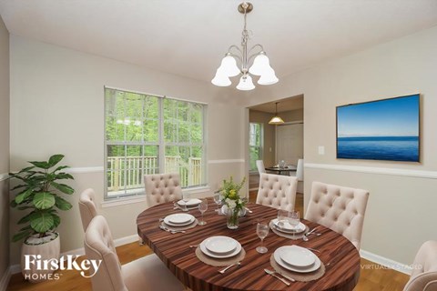 A dining room with a wooden table set for six.