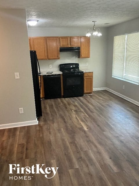 A kitchen with wooden cabinets and black appliances.