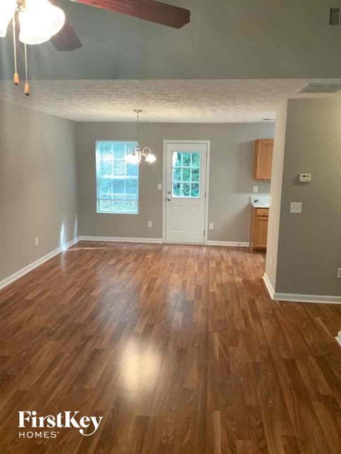 an empty living room with a hard wood floor
