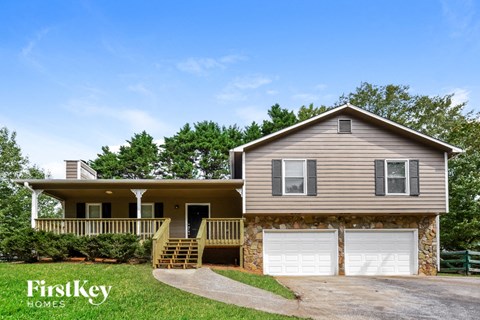 a house with two garage doors in front of it