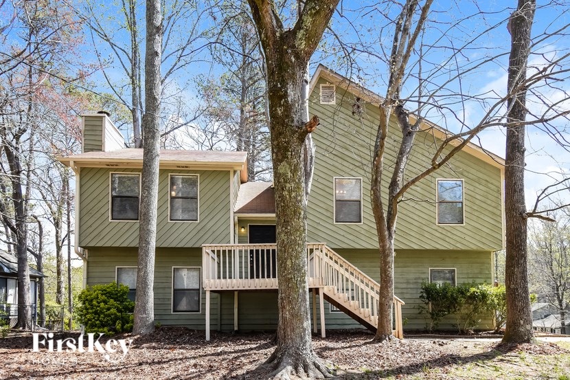 A two-story house with a balcony and a deck.