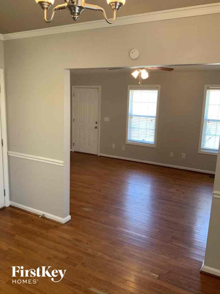 A room with wooden floors and a chandelier.