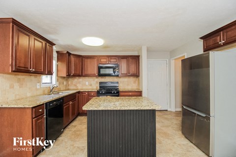 a kitchen with a counter top and a refrigerator