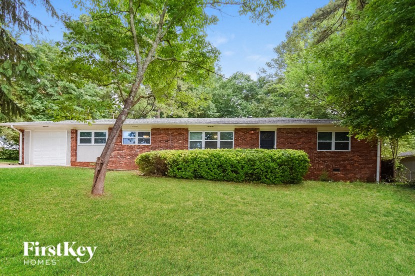 a brick house with a lawn in front of it