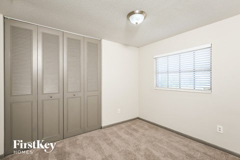 a bedroom with a closet and a window