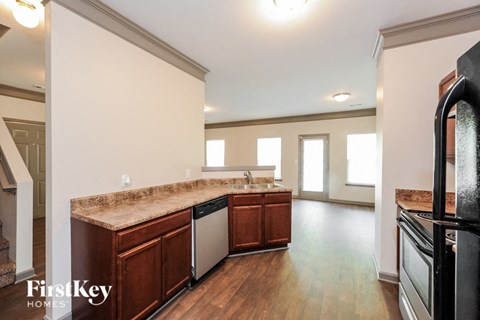 A kitchen with wooden cabinets and a granite countertop.