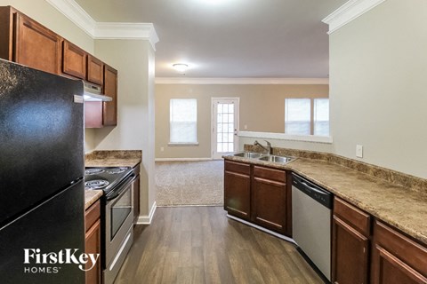 a kitchen with wooden cabinets and stainless steel appliances