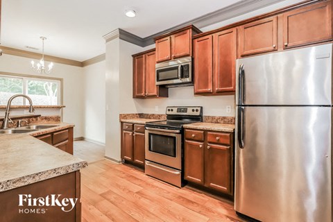 A kitchen with wooden cabinets and stainless steel appliances.
