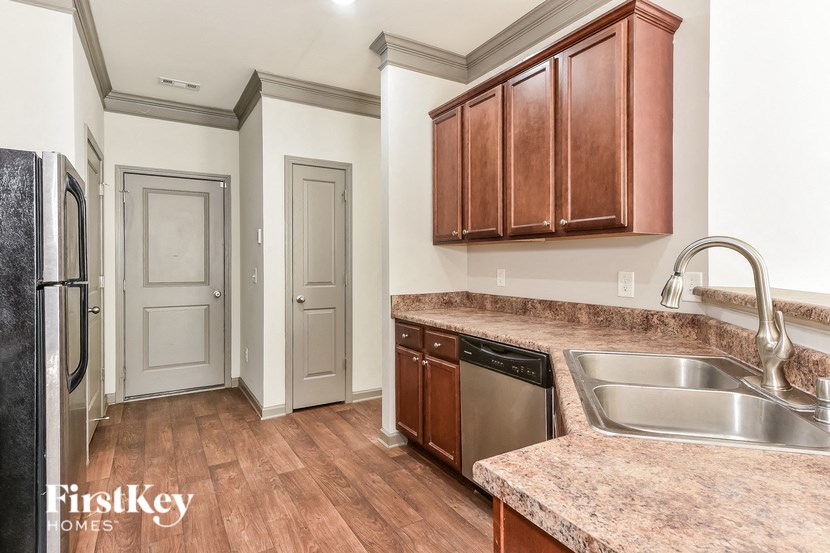a kitchen with granite counter tops and a stainless steel sink