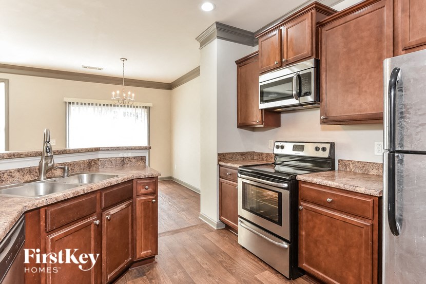 a kitchen with wooden cabinets and stainless steel appliances