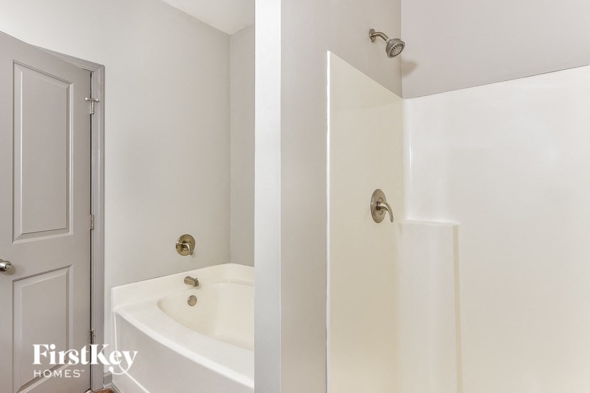 a bathroom with a sink and a shower and a door