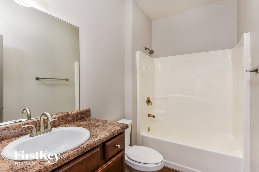 a bathroom with a sink and a shower and a toilet