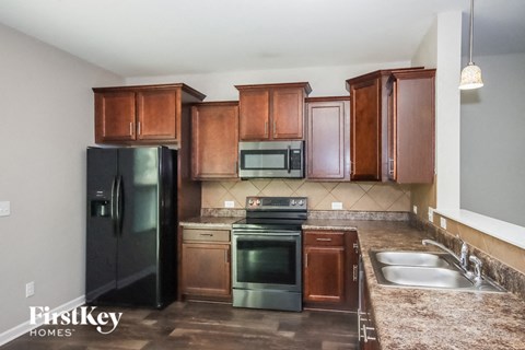 a kitchen with stainless steel appliances and wooden cabinets