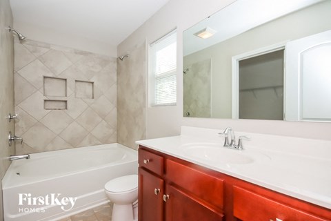 a bathroom with a sink toilet and a bath tub