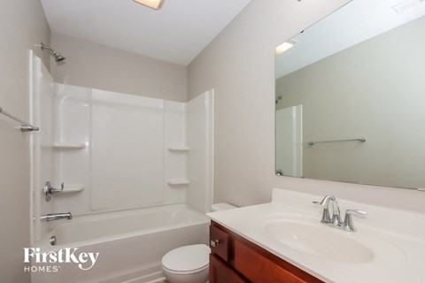 a bathroom with a sink and a toilet and a bath tub