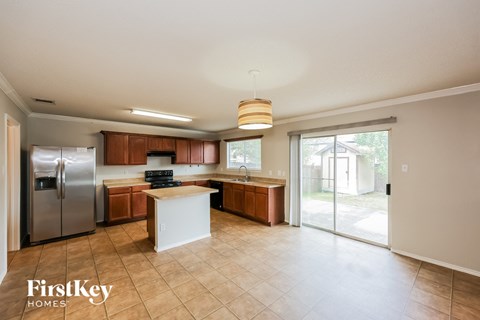 A kitchen with a refrigerator, stove, and oven is shown.