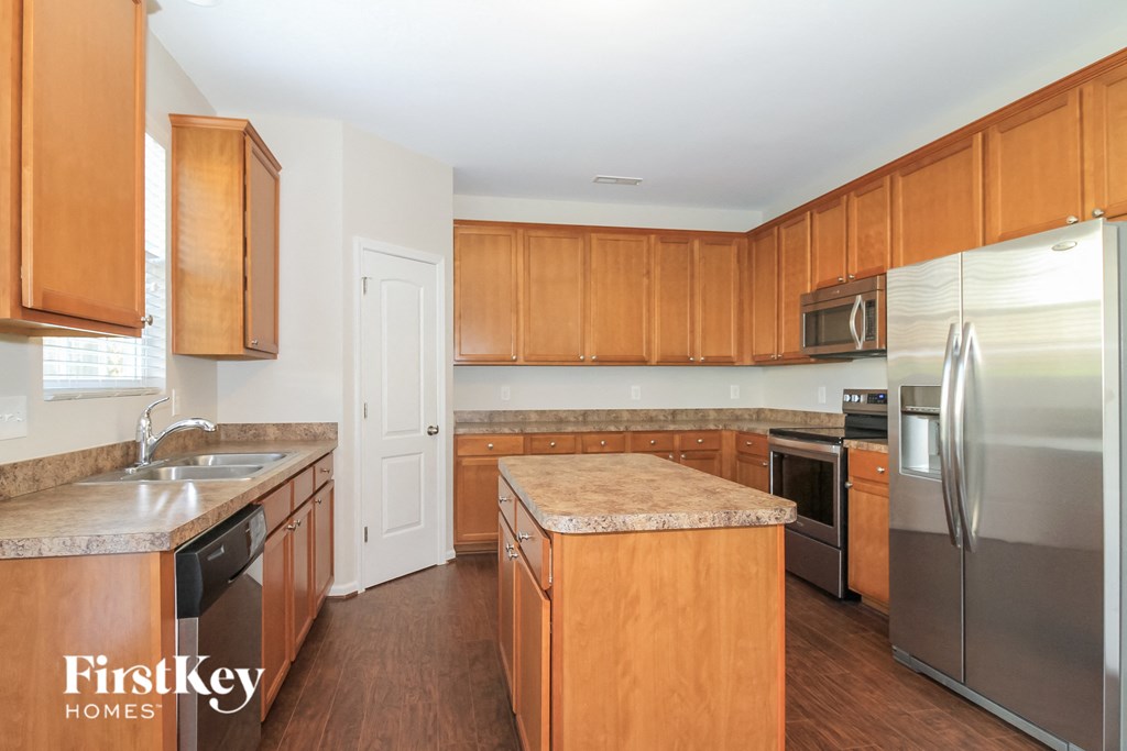 A kitchen with wooden cabinets and stainless steel appliances.