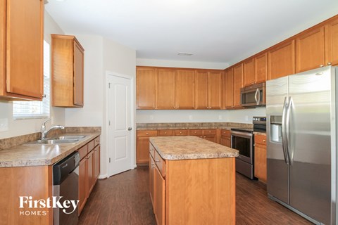 A kitchen with wooden cabinets and stainless steel appliances.