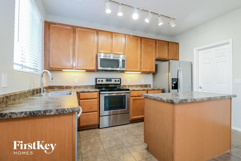 a kitchen with wooden cabinets and stainless steel appliances