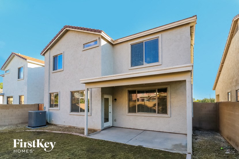 a white house with a sidewalk in front of it