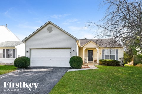 A white house with a garage is shown in the image.