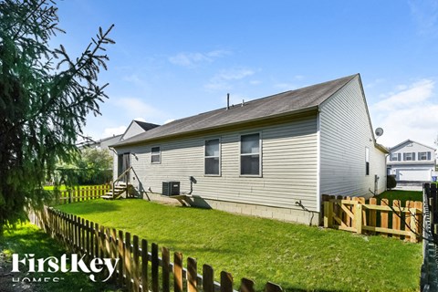 A house with a fence in front of it.