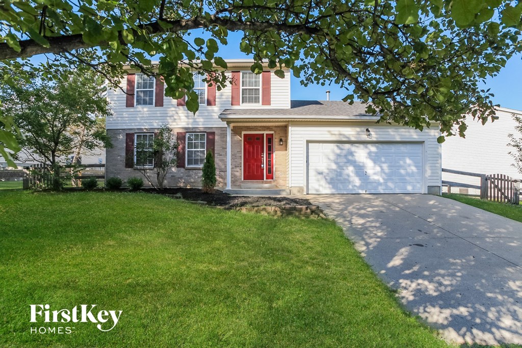 A house with a red door is for sale by FirstKey Homes.
