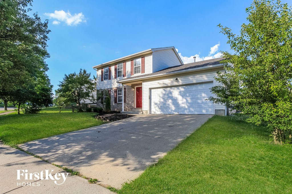 A house with a red door is for sale by FirstKey Homes.