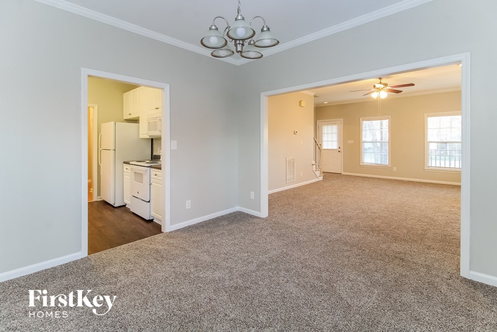 the living room and kitchen of an empty house